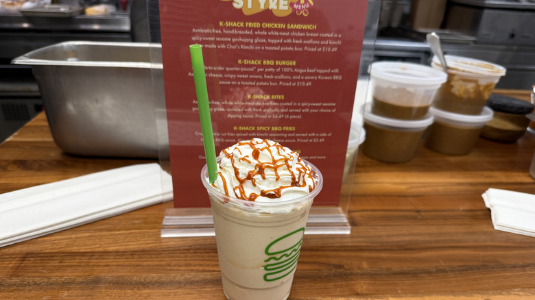 K-Shack Spicy Caramel Shake in front of a menu