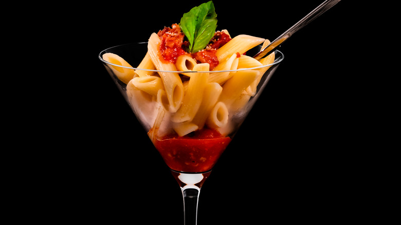 Penne pasta and tomato sauce in martini glass