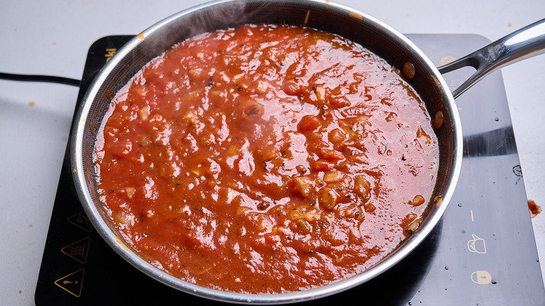 tomato and seasonings simmering in a skillet