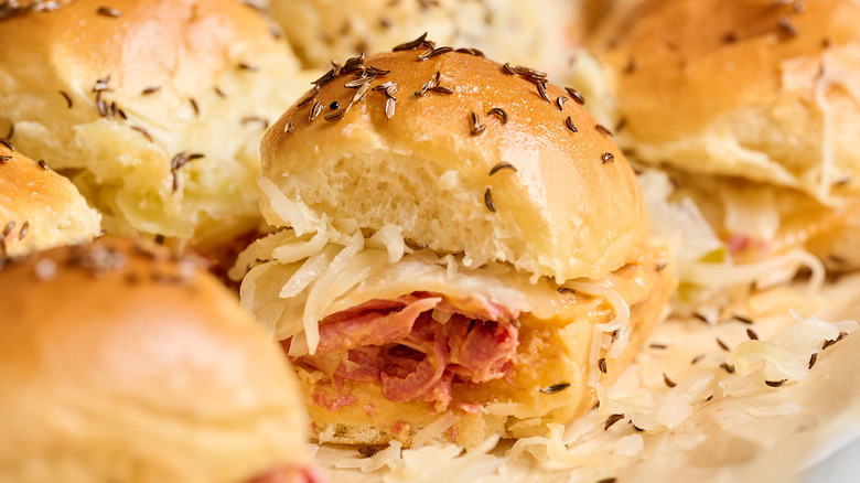 reuben slider on a table surrounded by other sliders