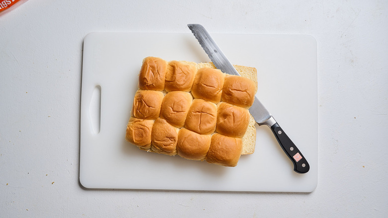 slicing rolls in half on a cutting board