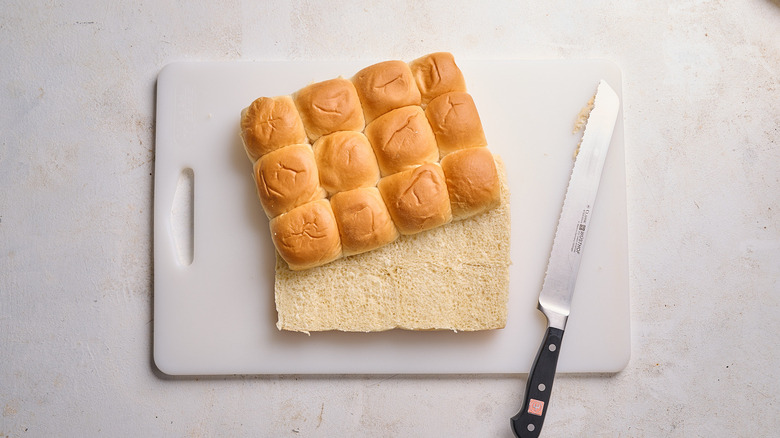 slicing rolls into a top half and bottom half