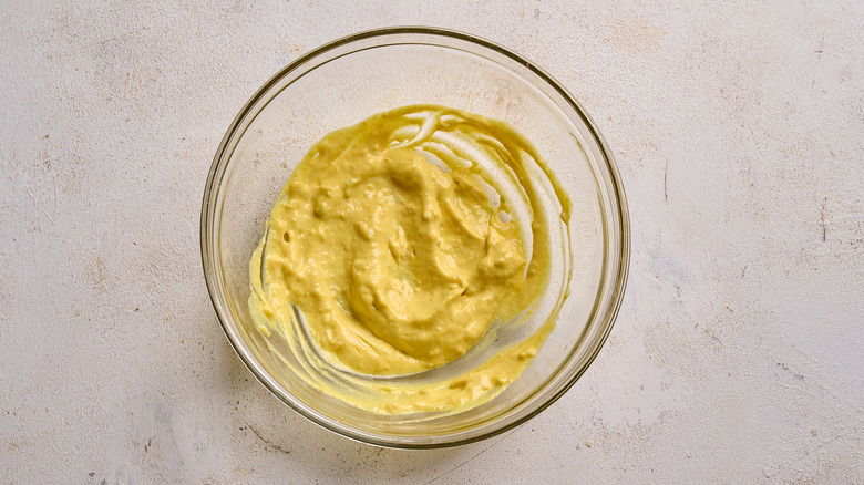 mixing mustard and mayo together in a bowl