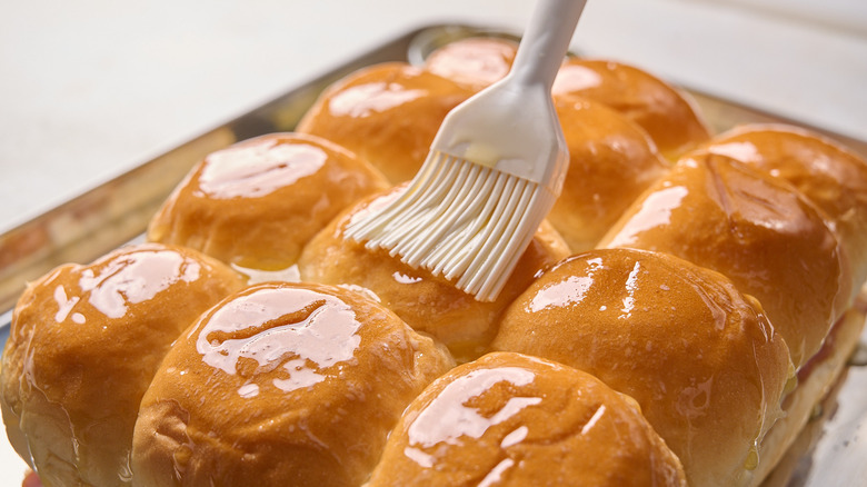 brushing buns with butter