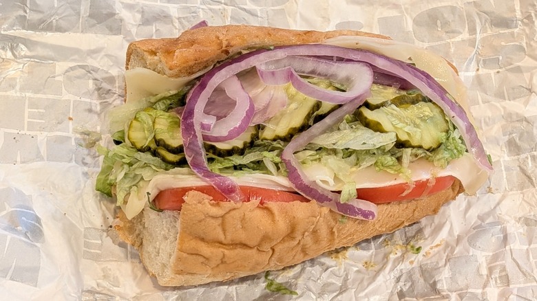 A small Sheetz turkey sub piled high with veggies on a wax paper