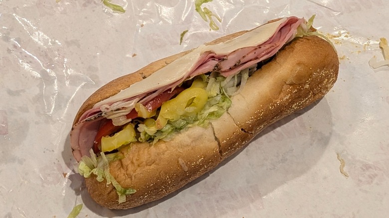 Wawa's Italian sub with meat and cheese poking out on wax paper