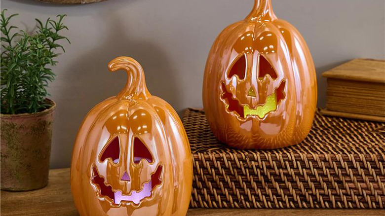 Two orange ceramic Jack-O-Lanterns by Valerie