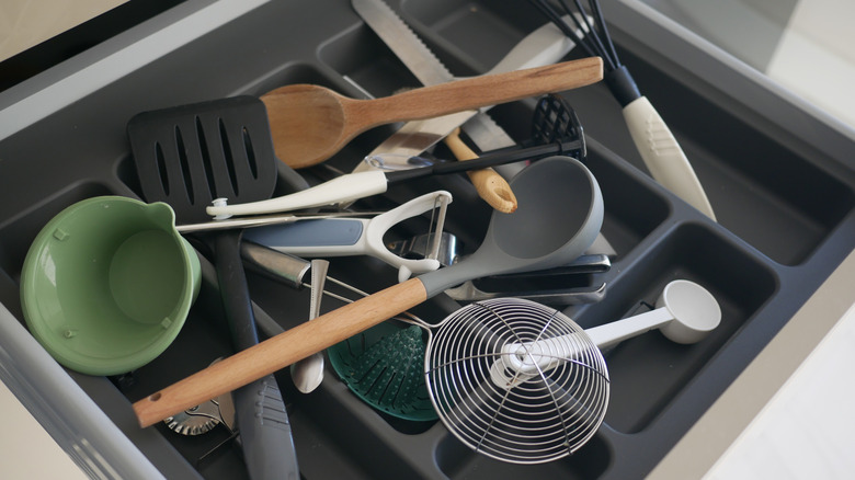 Messy kitchen door full of tools on top of useless organizer