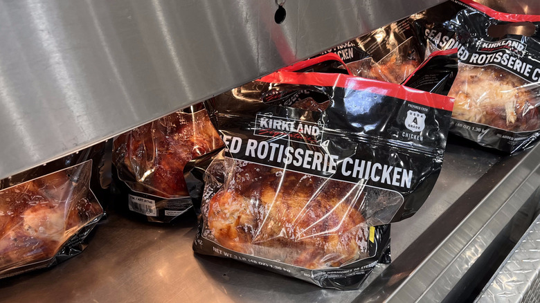 Kirkland Signature rotisserie chicken in plastic bag under warmer