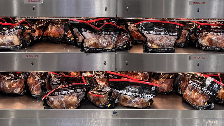 Costco rotisserie chickens under warmer in plastic bags