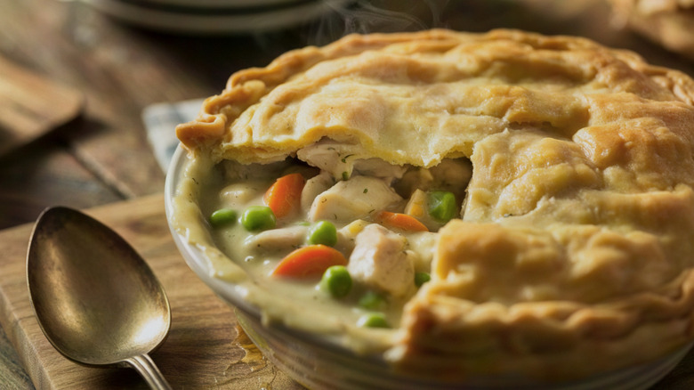 Chicken pit pie in baking dish next to silver spoon