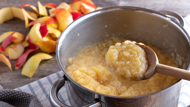 homemade applesauce and wooden spoon