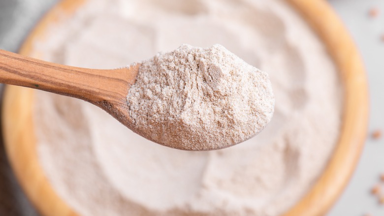 spoon scooping whole-grain flour