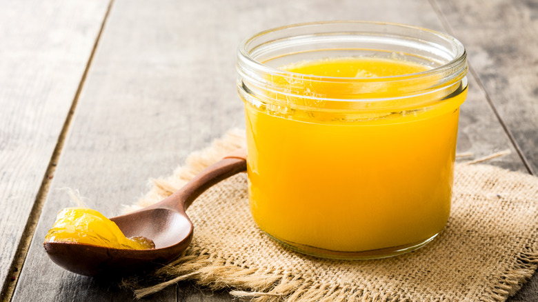 ghee in a pot with wooden spoon