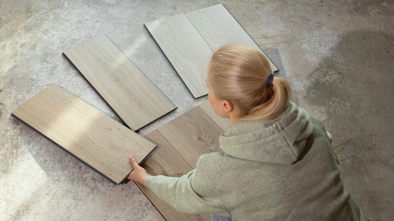 person looking at different styles of flooring