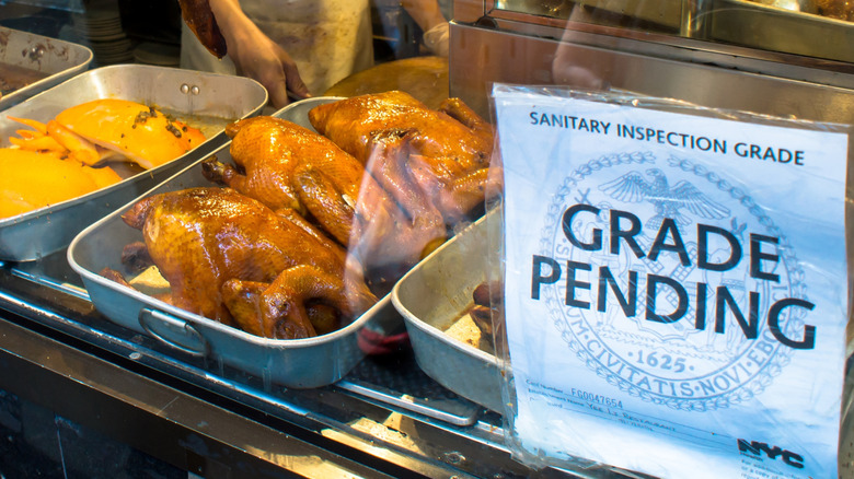 a "grade pending" sanitary inspection grade posted in front of food in a restaurant window