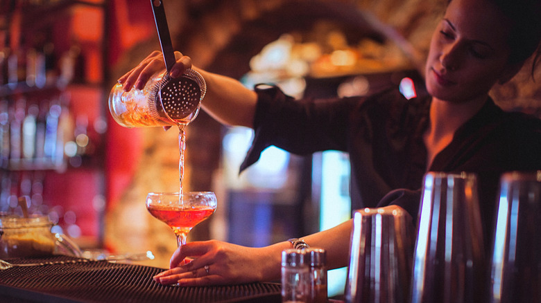 bartender pouring a cocktail
