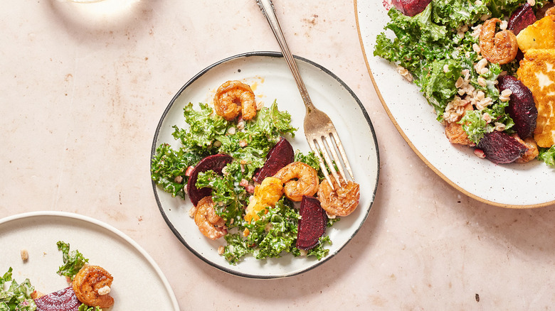 shrimp and beet salad on white plate with fork