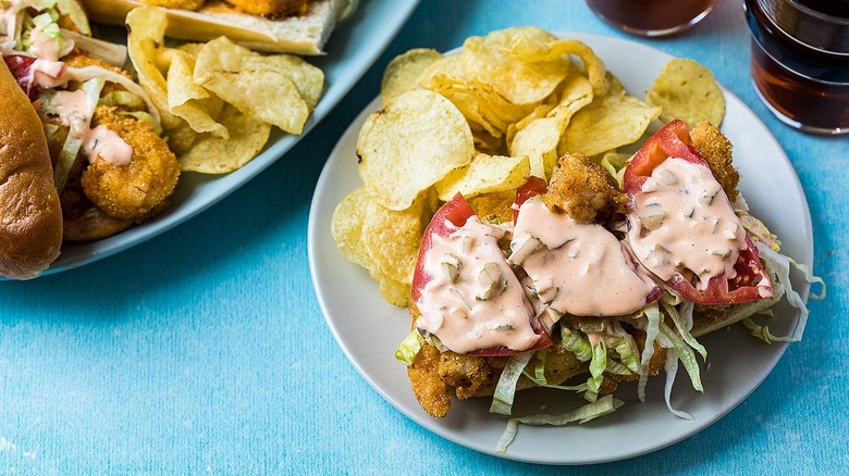 shrimp sandwich on plate with chips