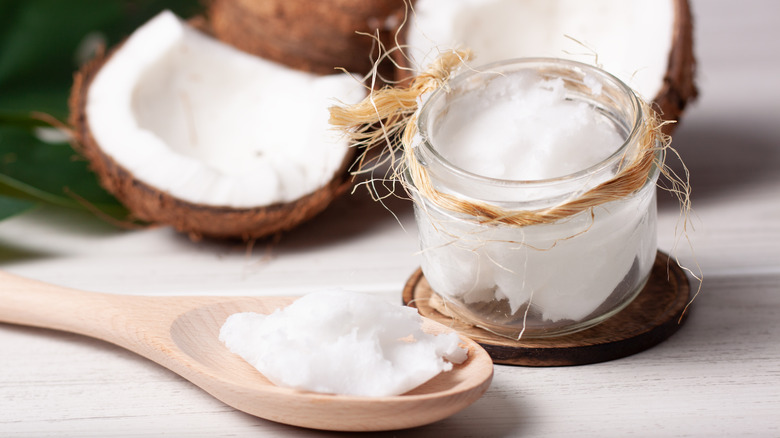 jar and wooden spoon of coconut oil