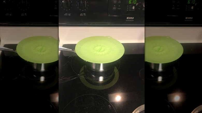 Green silicone lid on pot on stove