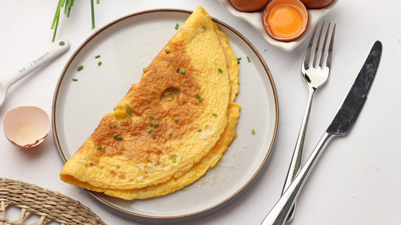 Plain omelet on plate with chives