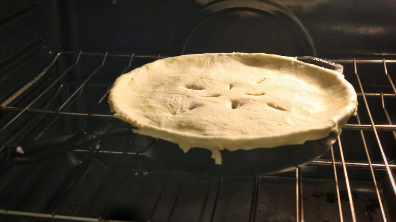 cast iron skillet topped with puff pastry in the oven