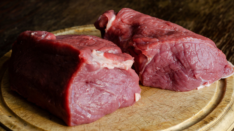 two cuts of raw beef roasts