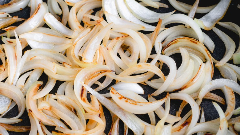 closeup of onions browning in skillet