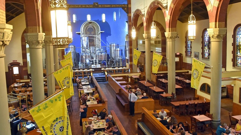 high angle of a church with dining tables and large tanks at the altar