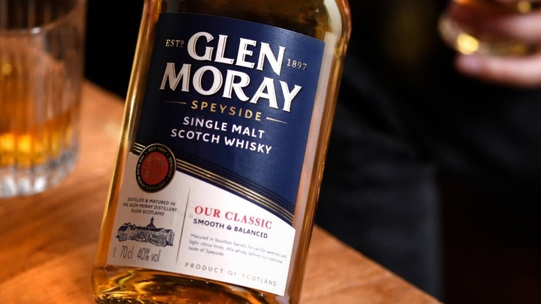 A close-up of a bottle of Glen Moray showcasing the label with a blurred background