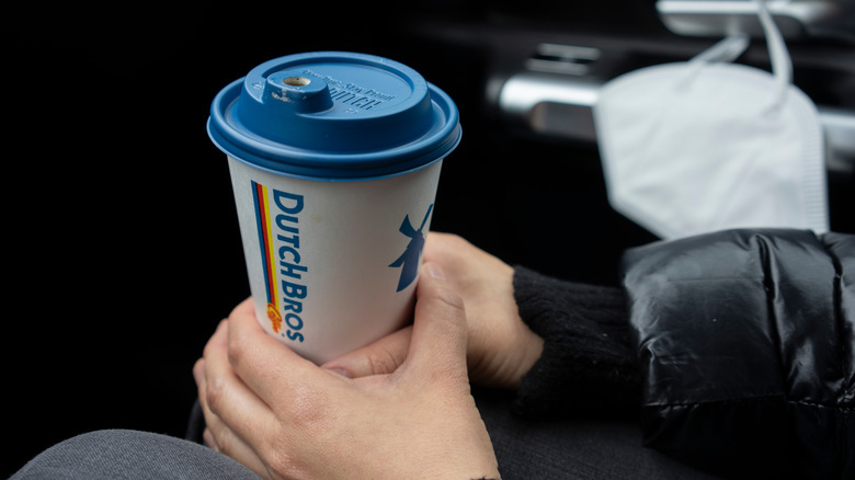 customer holding Dutch Bros drink
