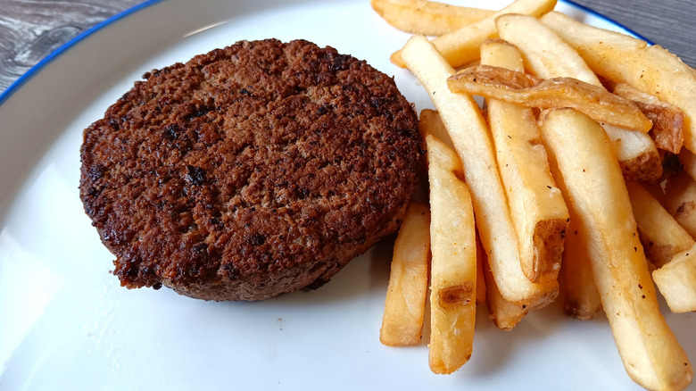 LongHorn Steakhouse burger patty with fries on a white plate