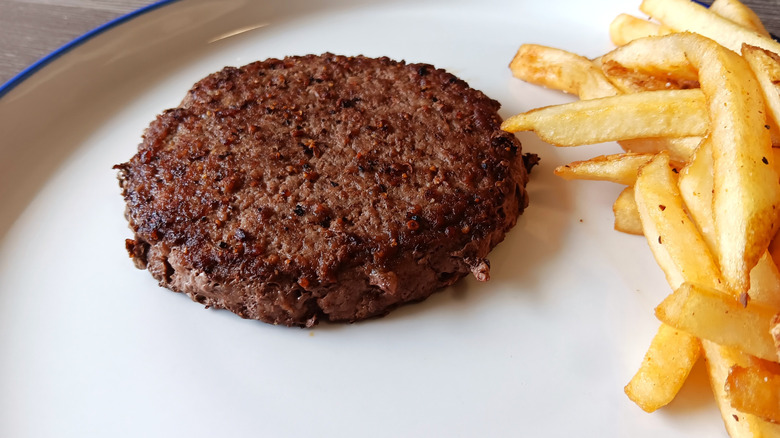 Ruby Tuesday burger patty on a plate with fries