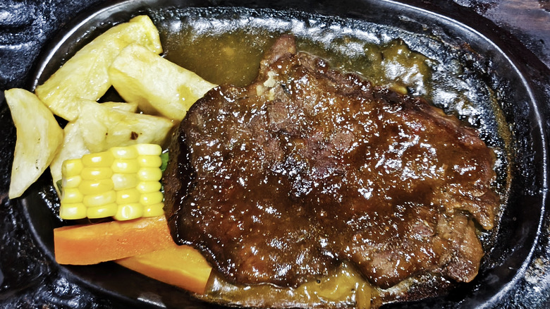 sliced rare thin steak on platter