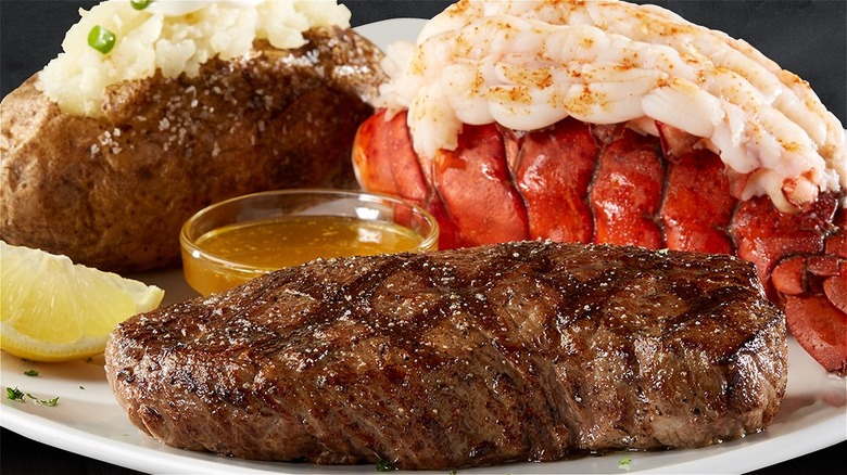 steak, lobster tail, and baked potato