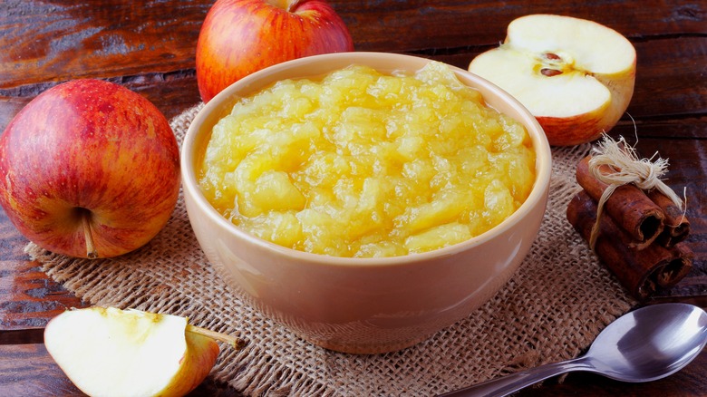 Homemade applesauce in bowl and ingredients
