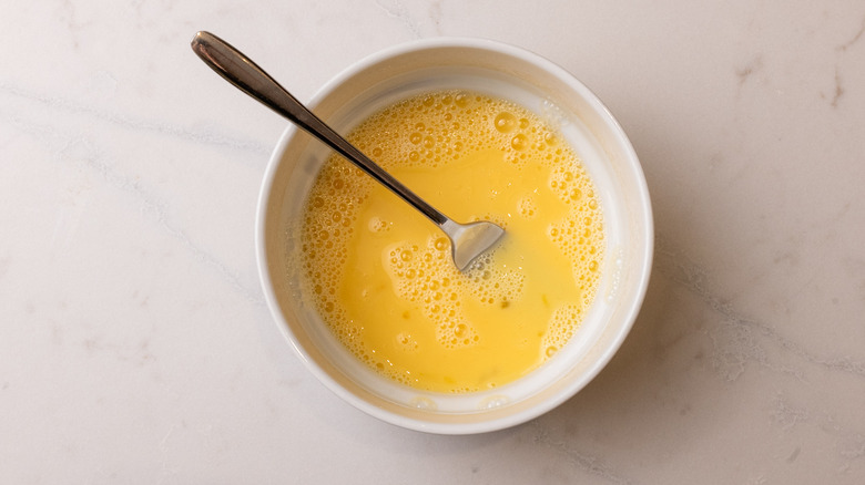 whisked eggs in a bowl with fork