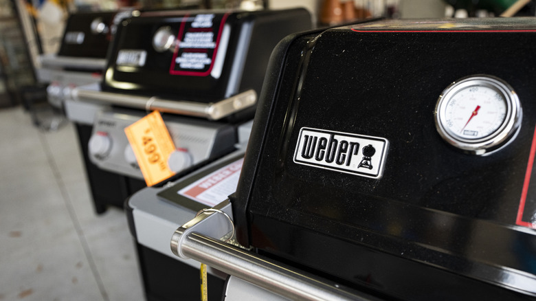 Closeup of Weber grills on sale at a store.