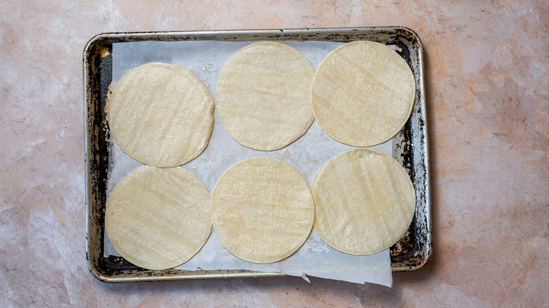 Tortillas brushed with oil on baking sheet