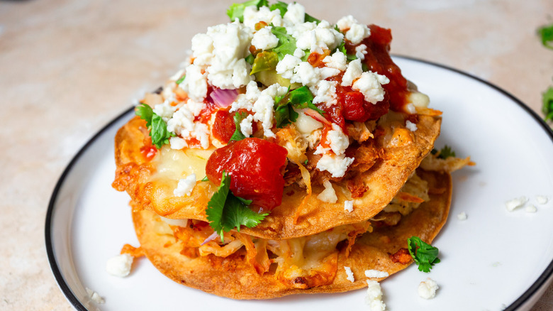 Two stacked baked chalupas on plate