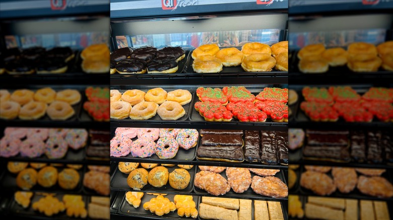 A wide selection of colorful donuts inside a case at Quicktrip
