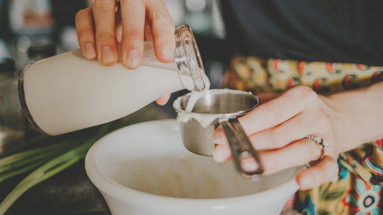 Person making ranch dressing