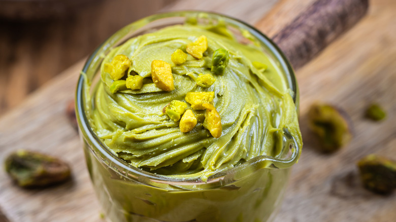 a close up of homemade pistachio butter in a jar