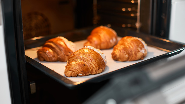 A tray of croissants coming out of the oven