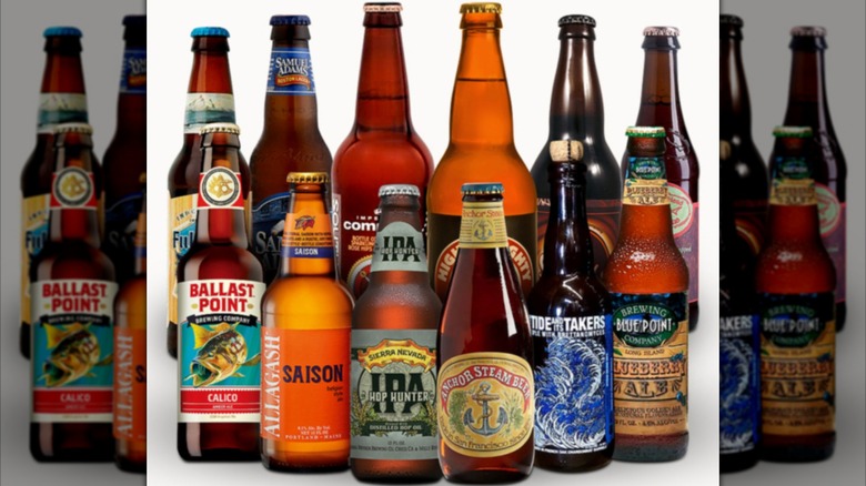 Assortment of bottled craft beers including Sierra Nevada, Anchor Steam, Ballast Point, and many more on a white background