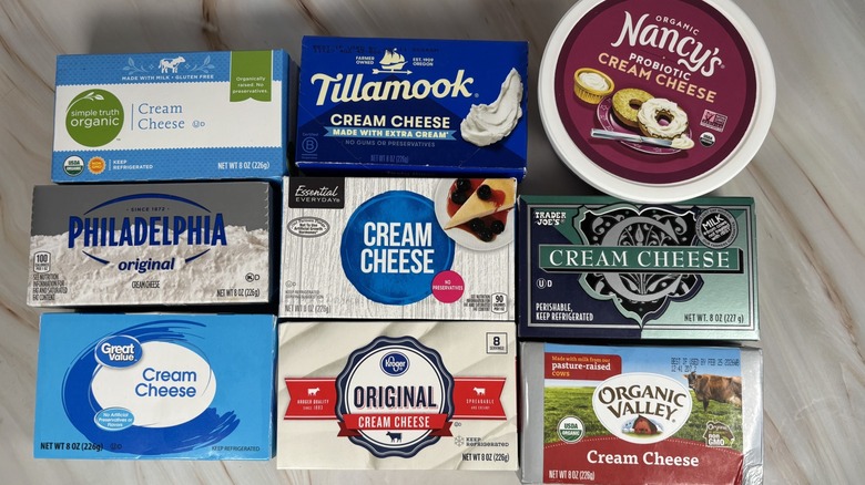 Overhead view of store-bought cream cheese brands on a table