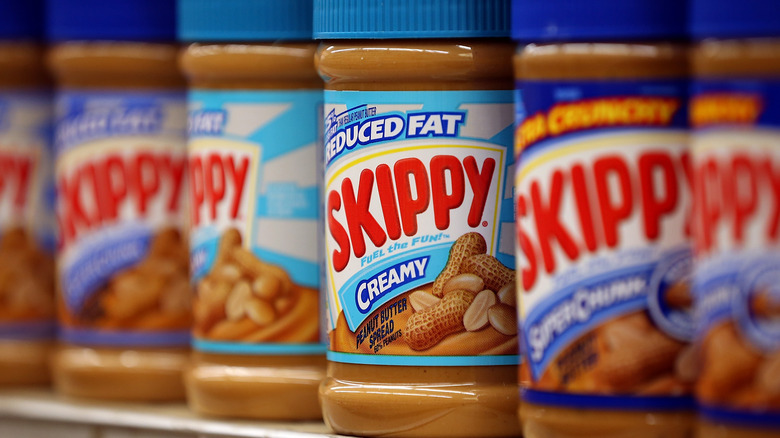 Jars of Skippy peanut butter on store shelf