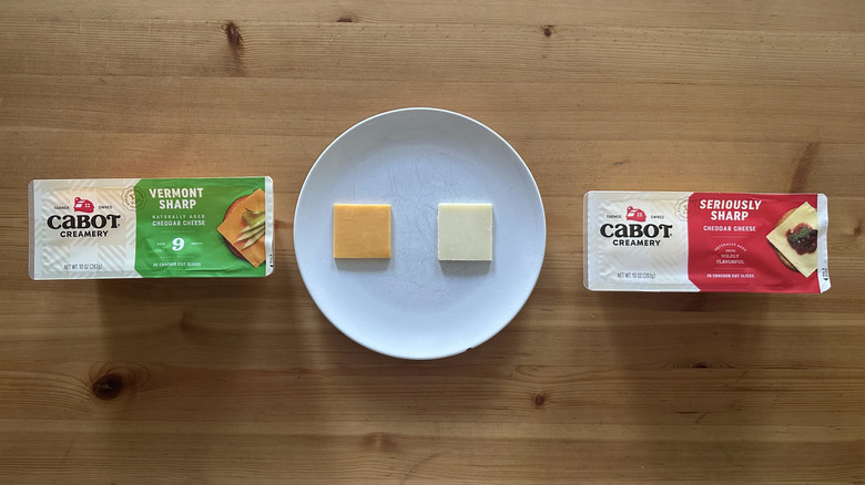 Packages of Cabot sliced cheese on wooden table