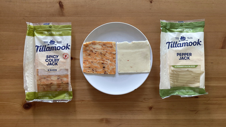 Packages of Tillamook sliced cheese on wooden table